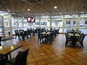 a restaurant with tables, chairs, and tables in it at Hostal Real in Plasencia