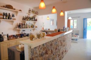 a kitchen with a counter with bottles on the wall at Dream Island Hotel in Livadia