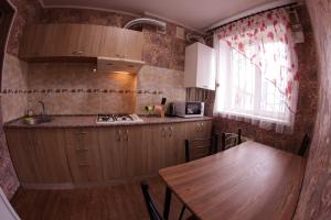 a kitchen with a wooden table and a wooden tableablish at Шевченко 2 in Kropyvnytskyi