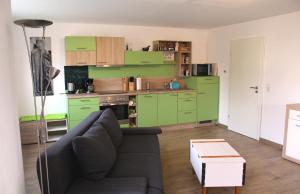 a living room with green cabinets and a couch at Ferienwohnung Andreas in Naumburg