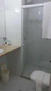 a bathroom with a shower with a toilet and a sink at Flat Vista Mar Frente ou Lateral na Barra em Salvador in Salvador +26 photos
