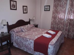 Ein Bett oder Betten in einem Zimmer der Unterkunft Hostal Rocio