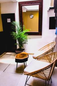 une pièce avec deux chaises, une table et un miroir dans l'établissement Hotel Sayab 5ta Avenida, à Playa del Carmen