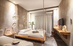 a bedroom with two beds and a swing at Olea House in Limenaria