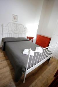 a bedroom with a white bed with a gray blanket at Agriturismo Villalta in Ponte Felcino