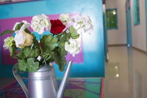 
a vase filled with flowers on top of a table at Hostal Johnnier Macao Punta Cana in Punta Cana
