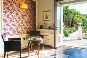 a dining room with a table and chairs and a fireplace at Relais La Placa in Francavilla di Sicilia