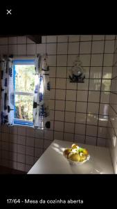 a bowl of fruit on a counter in a kitchen at Adega guest house in Horta +33 photos