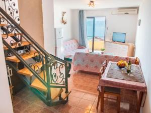 a staircase leading to a living room with a table at Apartment Stana in Novi Vinodolski