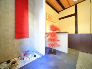 a room with a tree in the corner of a room at カモンイン 稲荷 in Kyoto +86 photos
