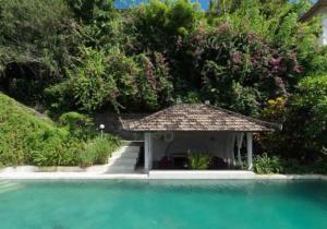 a gazebo sitting in the middle of the water at Baliku Dive Resort in Amed