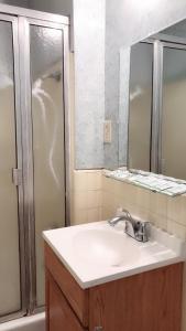 a bathroom with a sink and a shower at City Center Hotel Los Angeles in Los Angeles