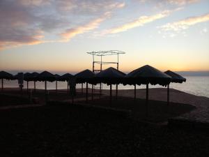 a group of umbrellas on a beach with the ocean at Apartman Sole in Karigador
