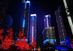 a group of tall buildings lit up at night at NAT i-city smart house in Shah Alam