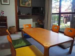 a dining room with a wooden table and chairs at Daikokuya Mt.Fuji in Fujiyoshida