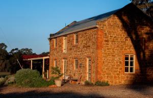 a brick building with a window and a roof at Byronsvale Vineyard and Accommodation in Bendigo