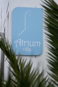 a blue sign on the side of a building at Atrium Villa in Fira