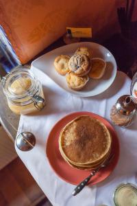 a table with a plate of pancakes and a plate of biscuits at Gästehaus Mezcalero in Dresden