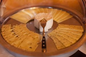 a close up of a plate with cheese and crackers at Gästehaus Mezcalero in Dresden
