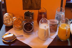 a table topped with glasses of milk and other items at Gästehaus Mezcalero in Dresden