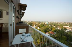 a balcony with a table and a view of a city at Shalom Residence Nawala in Colombo