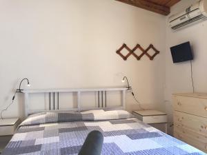 a bedroom with a bed and two night stands and a dresser at porta marina ortigia in Siracusa