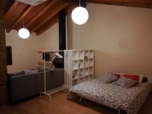 a bedroom with a bed and a shelf and lights at CA L'AVIADOR in Sarroca de Lérida