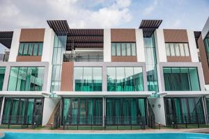 a building with a pool in front of it at Hermitage Boutique House in Taiping