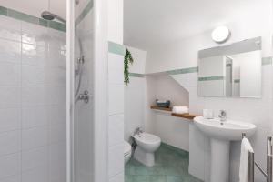 a white bathroom with a sink and a toilet at La rosa dei venti in Gaeta +25 photos