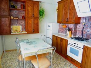 スームィにあるApartment on Svobodu aveのキッチン(テーブル、椅子、冷蔵庫付)