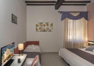 Postel nebo postele na pokoji v ubytování Hotel Amalfitana