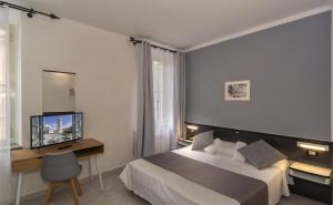 Postel nebo postele na pokoji v ubytování Hotel Amalfitana