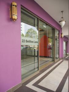 a purple building with a ballistics lane sign on it at Aqueen Heritage Hotel Little India in Singapore