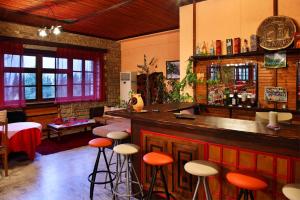 a bar with orange stools in a restaurant at Konitsa Panorama in Konitsa