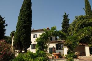 a large white house with trees in front of it at Villa Il Bosco in Fiesole