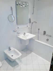 a white bathroom with a sink and a toilet at Old Town Square Apartments in Prague