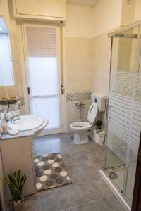 a bathroom with a toilet and a sink and a shower at Gabrielli Rooms & Apartments - FIERA in Verona