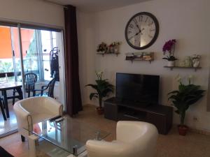 a living room with a clock on the wall at Apartment 2 bedrooms, 250m Levante beach in Benidorm
