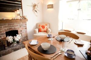 a dining room with a table and a fireplace at Spring Cottage B&B in Probus
