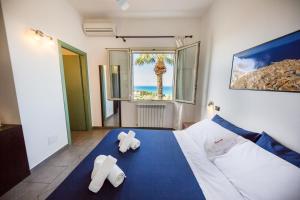 a bedroom with a bed with two teddy bears on it at Bouganville B&B in Cefalù