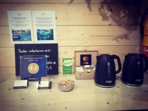 a table with a tea kettle and other items on it at Pensión Urkia in San Sebastián