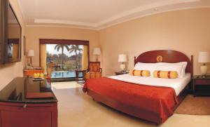 A bed or beds in a room at The Lalit Temple View