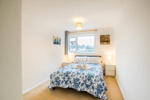 a bedroom with a bed with two stuffed animals on it at Comfy 2BR Flat with Wi-Fi in Bishop's Stortford in Bishops Stortford