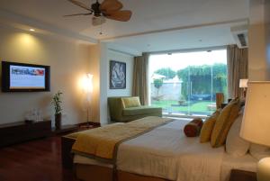 A bed or beds in a room at The Lalit Temple View