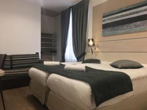 Postel nebo postele na pokoji v ubytování Coccodrillo Hotel & Apartments