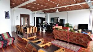 a living room with a couch and chairs and a table at Loft Apartment in Port Glasgow