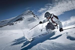 a person on skis jumping in the snow at Comfort Hotel Garni Landhaus Gitti in Zell am See