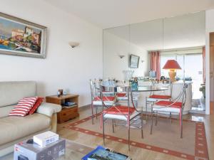 カンヌにあるWelkeys Apartment - Leaderのリビングルーム(ソファ、テーブル、椅子付)