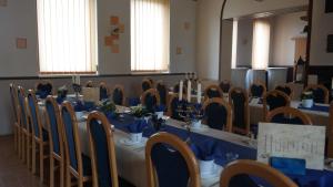 a room with a long table with blue table cloth at Landpension Wendfeld in Sanitz