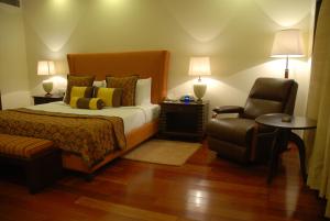 A bed or beds in a room at The Lalit Temple View